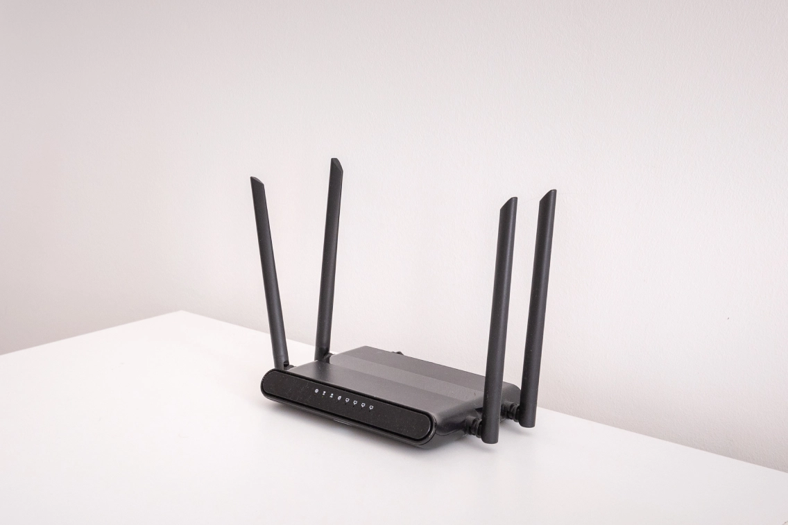 Black wireless router with four antennas.